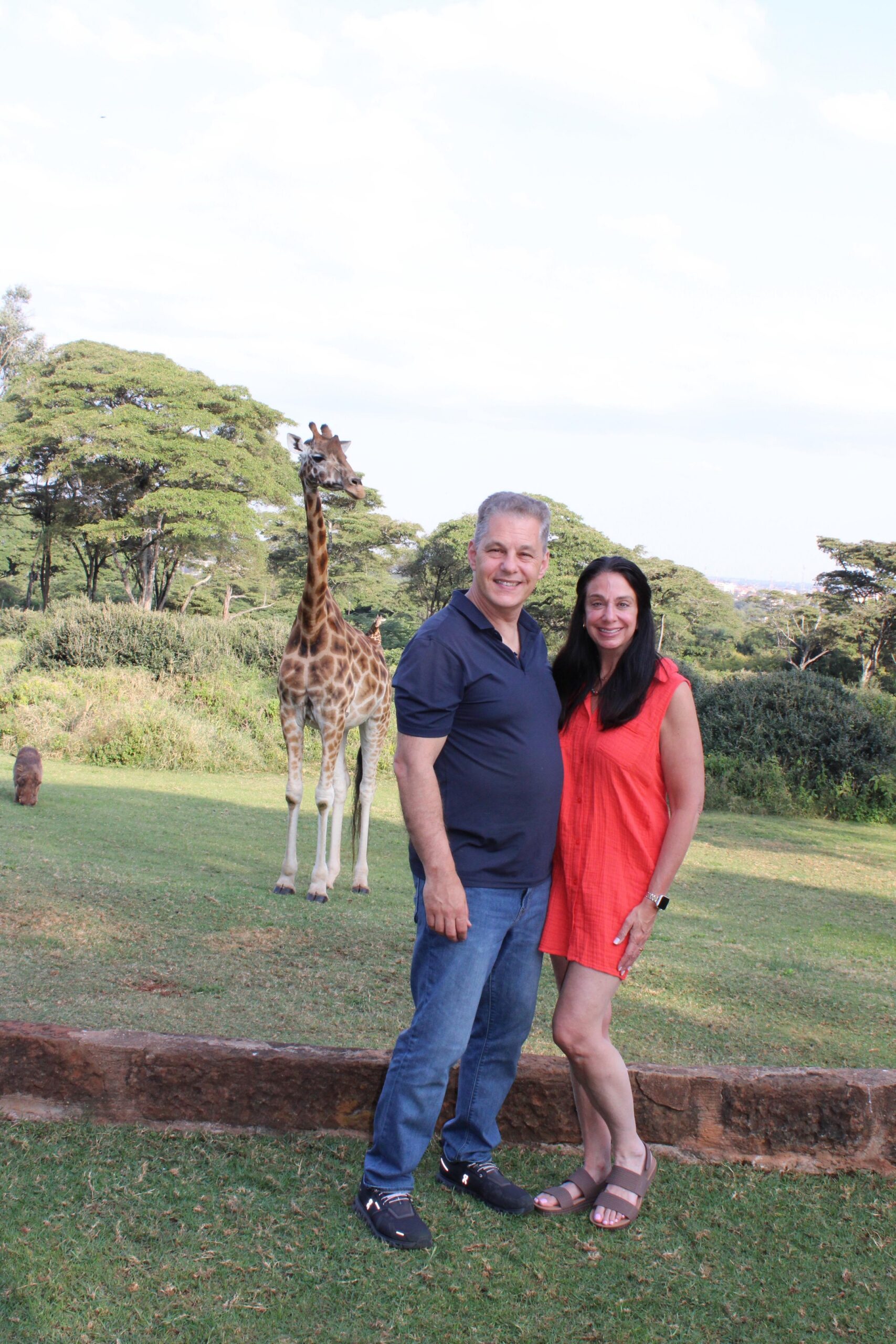 Artisans of Safari travelers sharing a close giraffe encounter